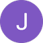 White capital letter J on a solid purple circle background.